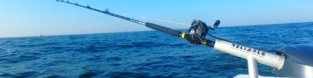 Close-up of fishing rod in a rod holder on a boat