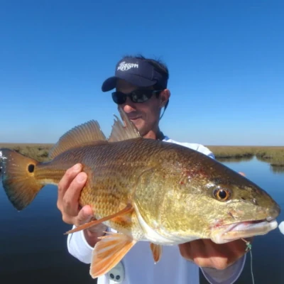 An angler holding a redfish