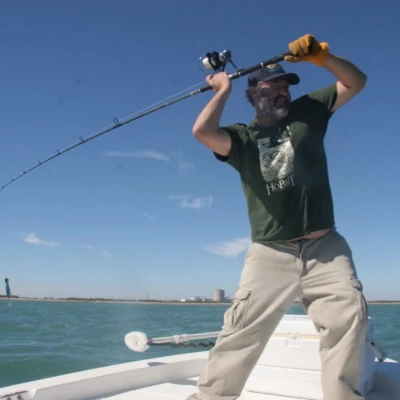 An angler cast his fishing rod from a boat