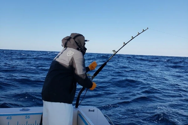 An angler fishing off a boat for bluefin