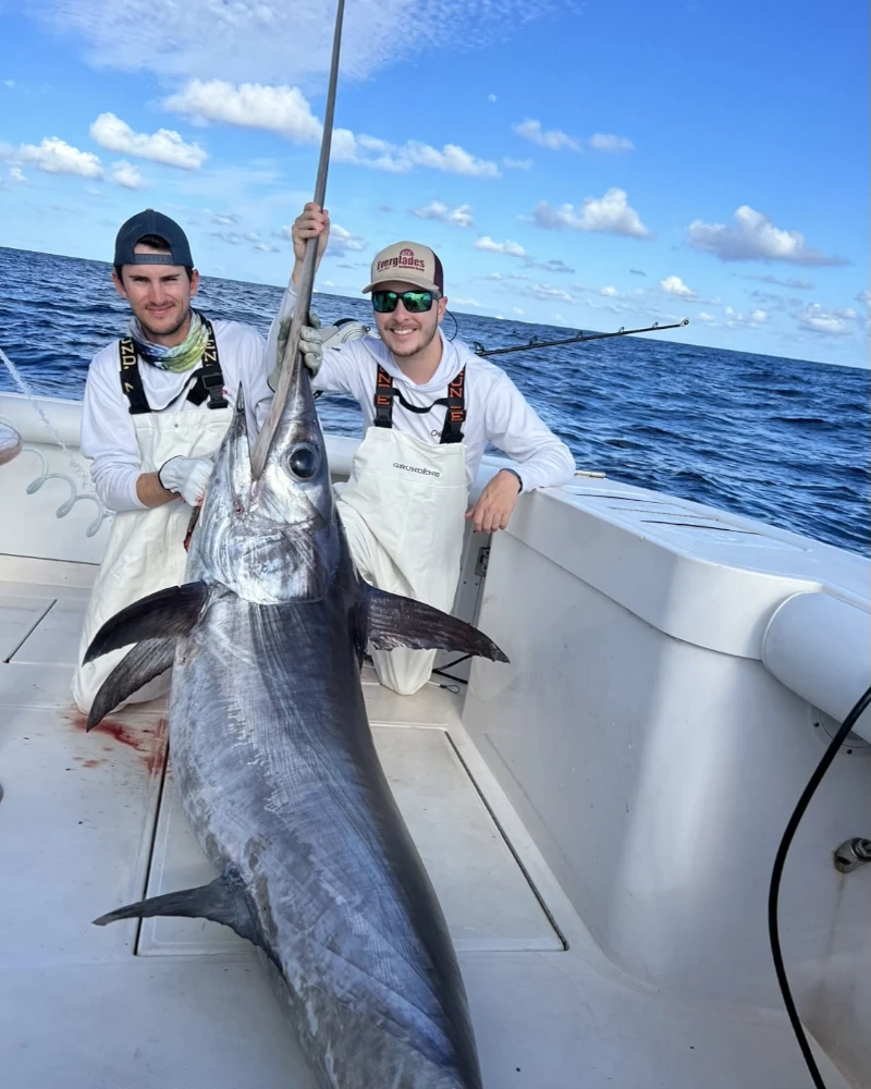 Two anglers showing off a swordfish
