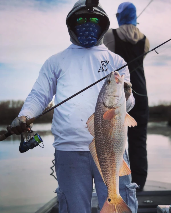 Dressing warm and catching red drum. Image provided by user @famousland_fishing