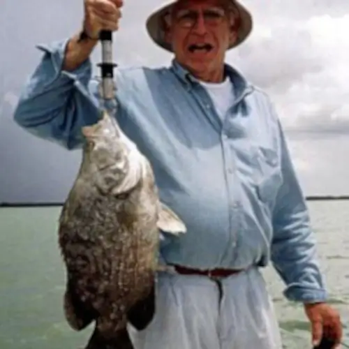 A man holding a triple tail fish