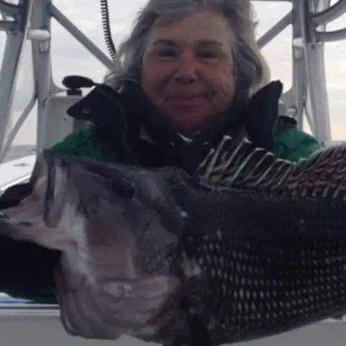 Maureen Klause holding a black fish