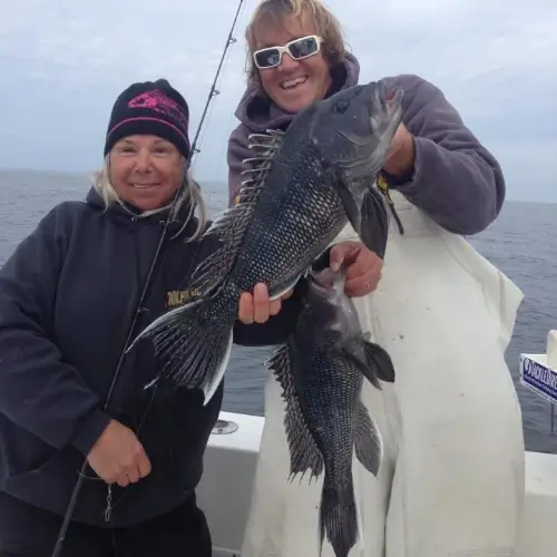 Maureen Klause and another angler on a boat each holding fish